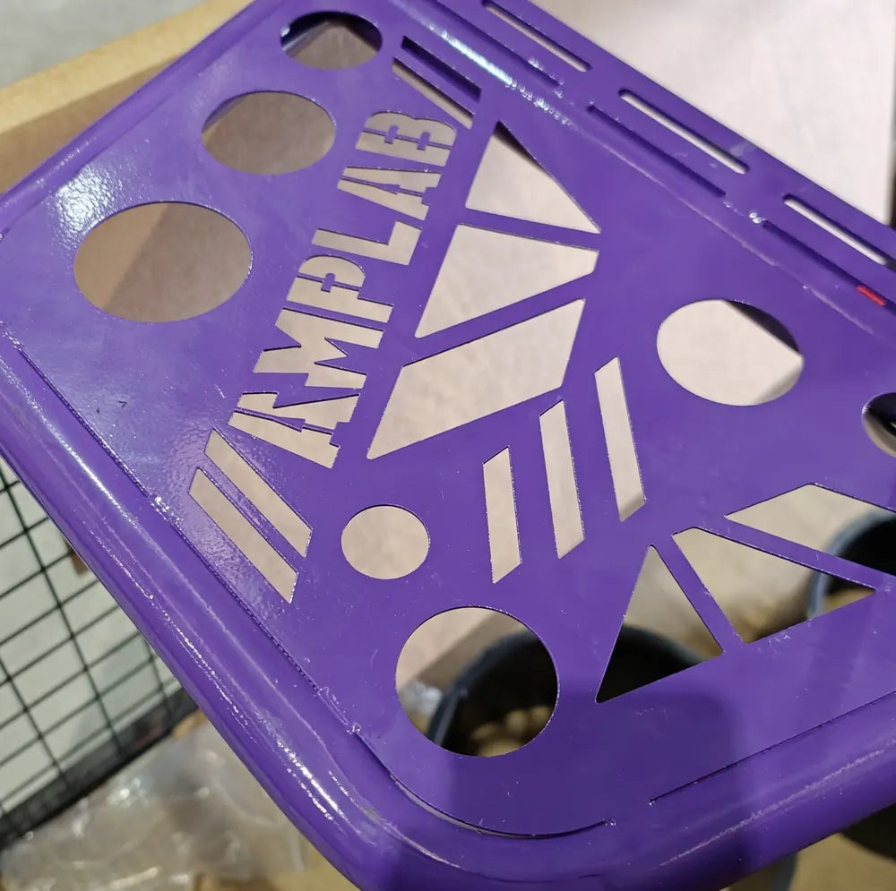 Cut-out floor pan with the AMPLAB logo